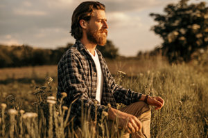 man meditating in field at a bulimia treatment center