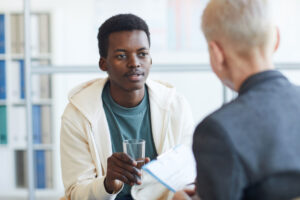 a man talks to a therapist about mental health stigma