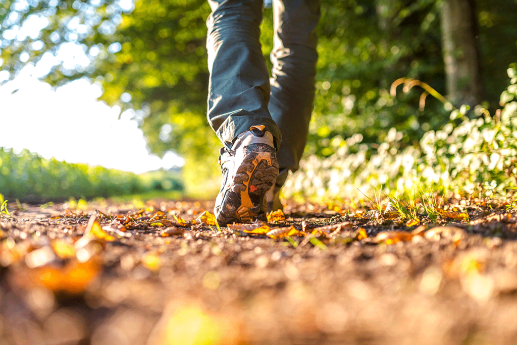 a young man in addiction recovery walks in nature