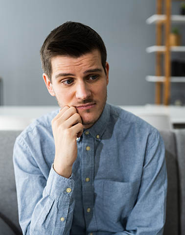 young adult sitting and thinking