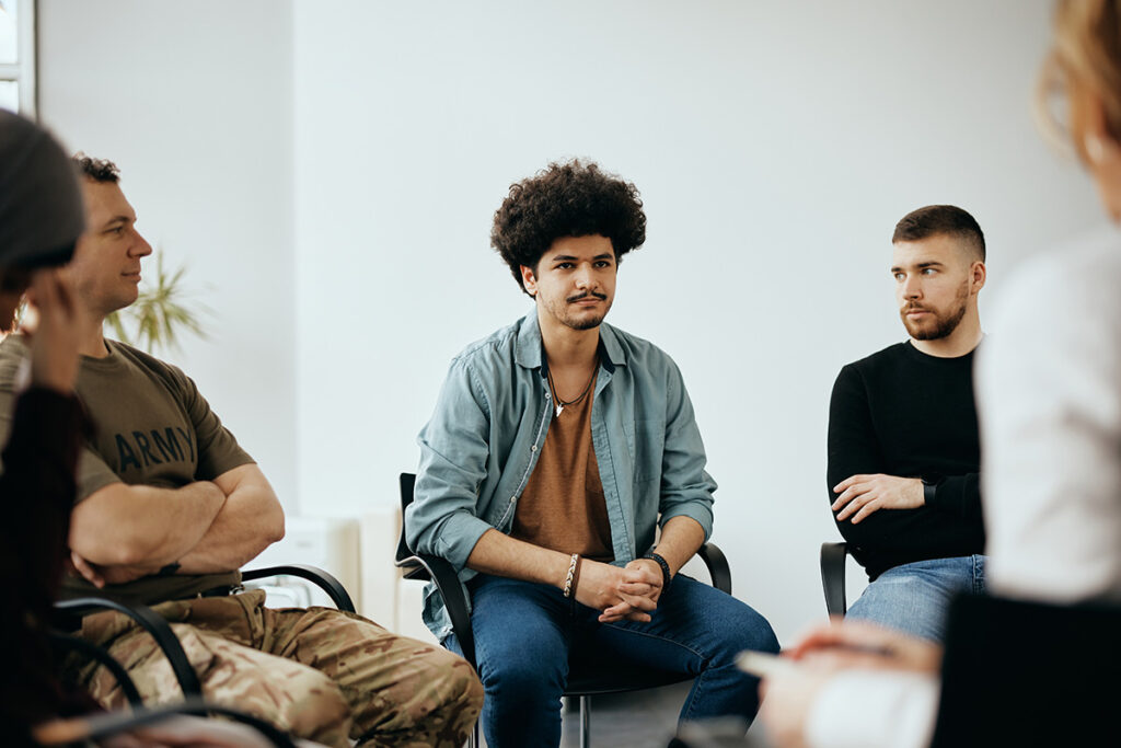 young men in a group learn about the stages of addiction recovery