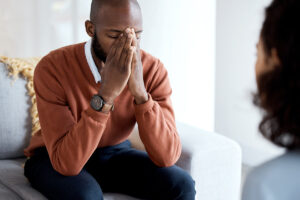 a man holds his hands together and closes his eyes while thinking of the alcoholics anonymous mantra