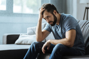 a man deals with a hangover in bed, possibly a sign of a secret drinking problem