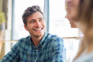 a person smiles at another during adderall addiction treatment for young adults 