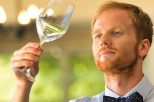 a person swirls a wine glass while considering alcohol induced dementia