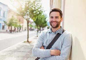 a young man smiles after enrolling in an anxiety treatment program