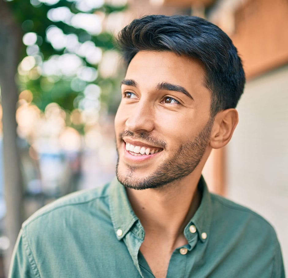 a young man smiles