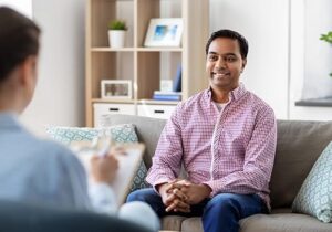 a young man in a marijuana addiction treatment center listens to a therapist