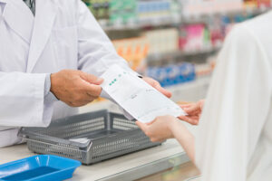 a pharmacist dispenses a medication to a client in a medication management program