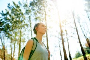 A young woman breathes in fresh air during therapeutic recreation