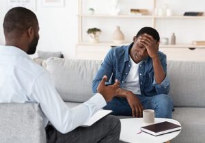 a man in a xanax addiction treatment center listens to a therapist
