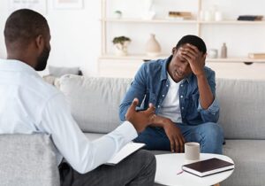 a young man in a xanax addiction treatment center listens to a therapist