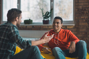 a young man smiles at a therapist during dialectical behavior therapy
