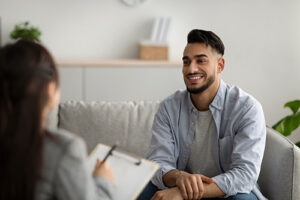 a young man speaks with a counselor during enrollment at Red Oak Recovery<sup>®</sup>