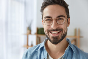 a young man smiles during cognitive-behavioral therapy