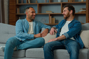 two young men talk in a group therapy program