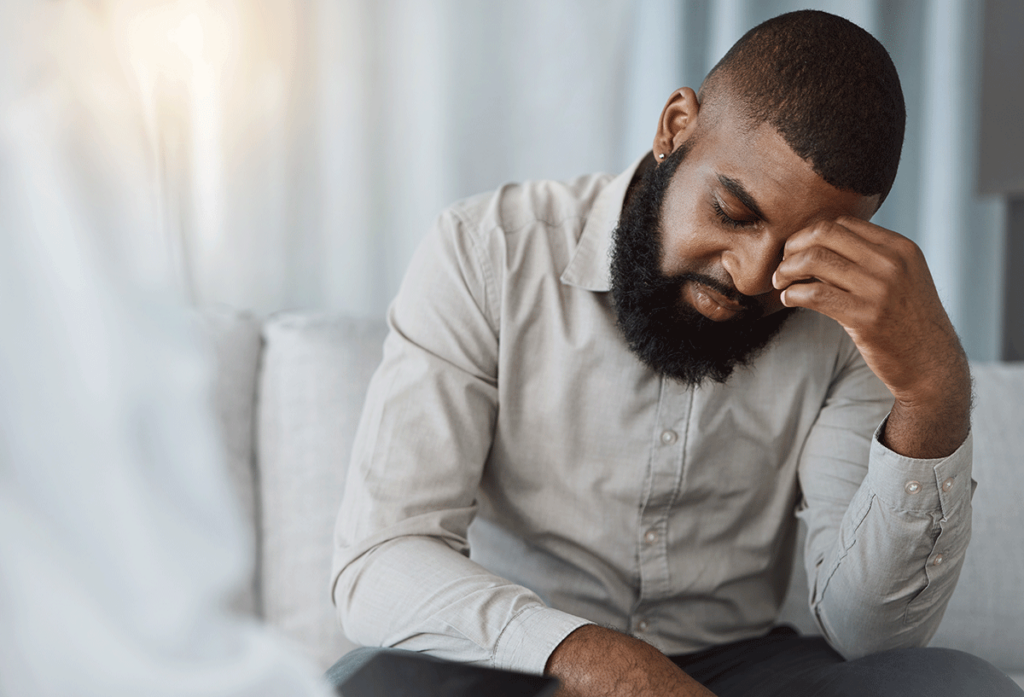 a young man holds his head after learning how are personality disorders treated