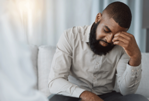 a young man holds his head after learning how are personality disorders treated