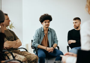 Several men in a men's rehab center