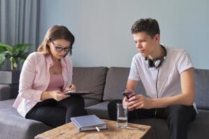 a young man talks with a counselor during meth addiction treatment