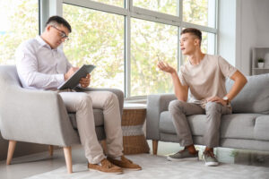 a man talks with a therapist in drug addiction rehab