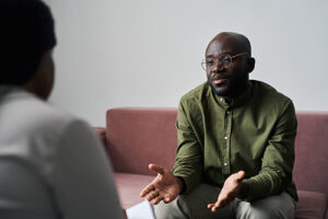 a man talks to a therapist during opioid addiction treatment