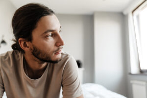 a person struggling with cross addiction sits and thinks